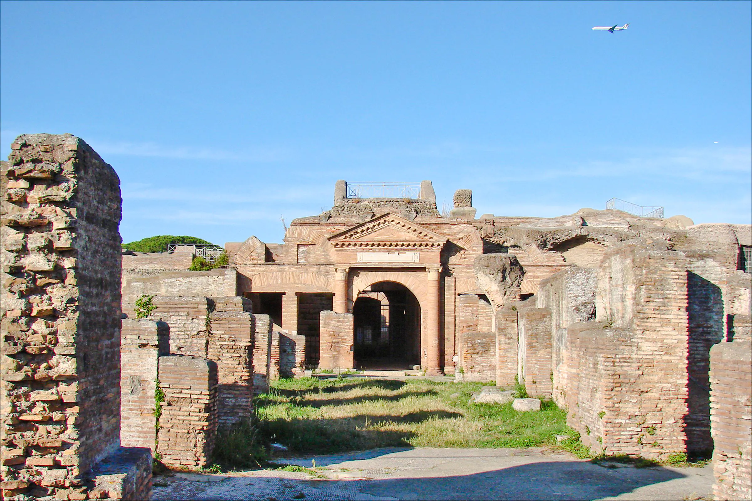 Ostia Antica ruins with ancient brick structures and archway, Rome.