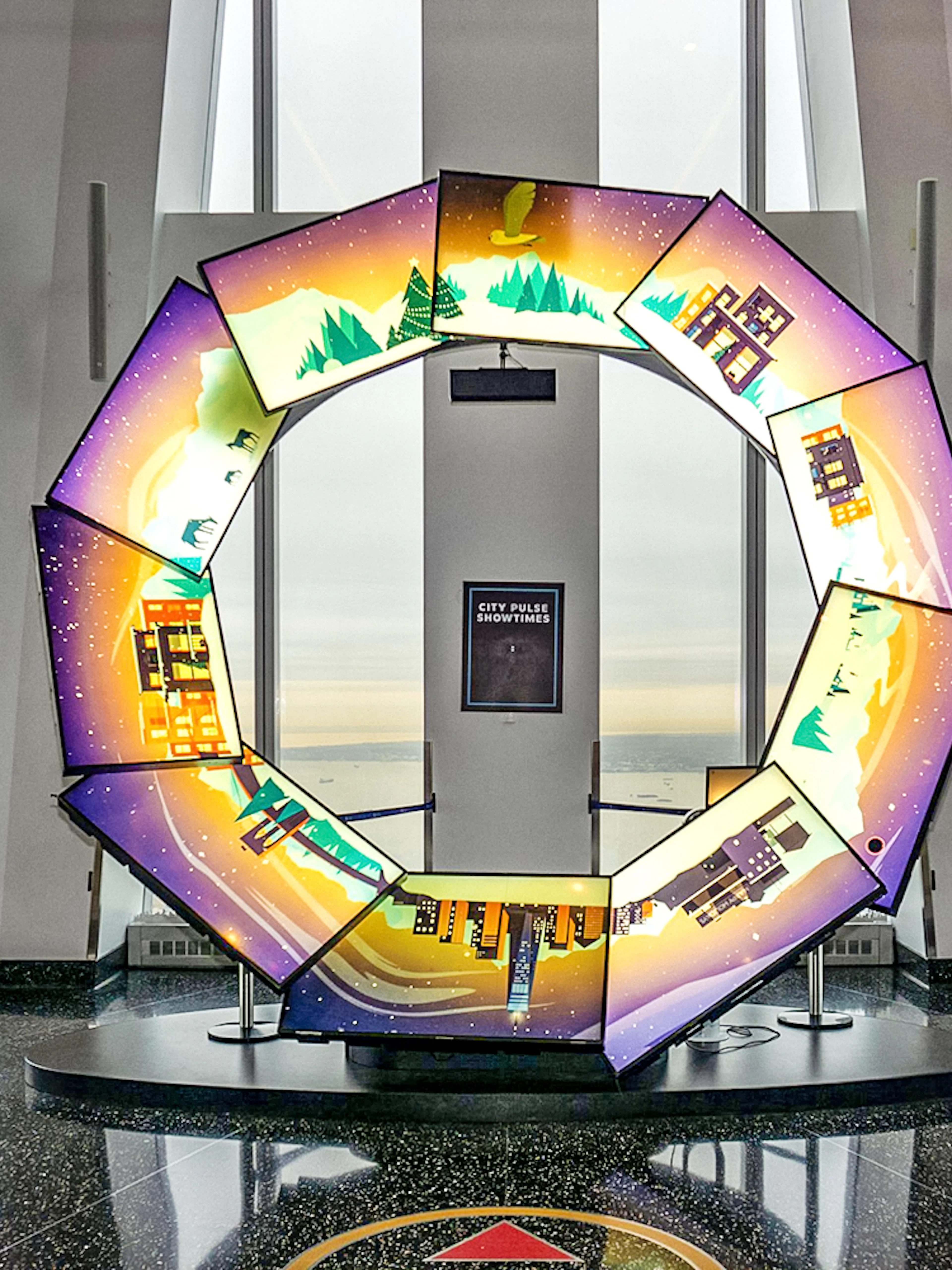 Interactive display at One World Observatory with city and nature scenes.
