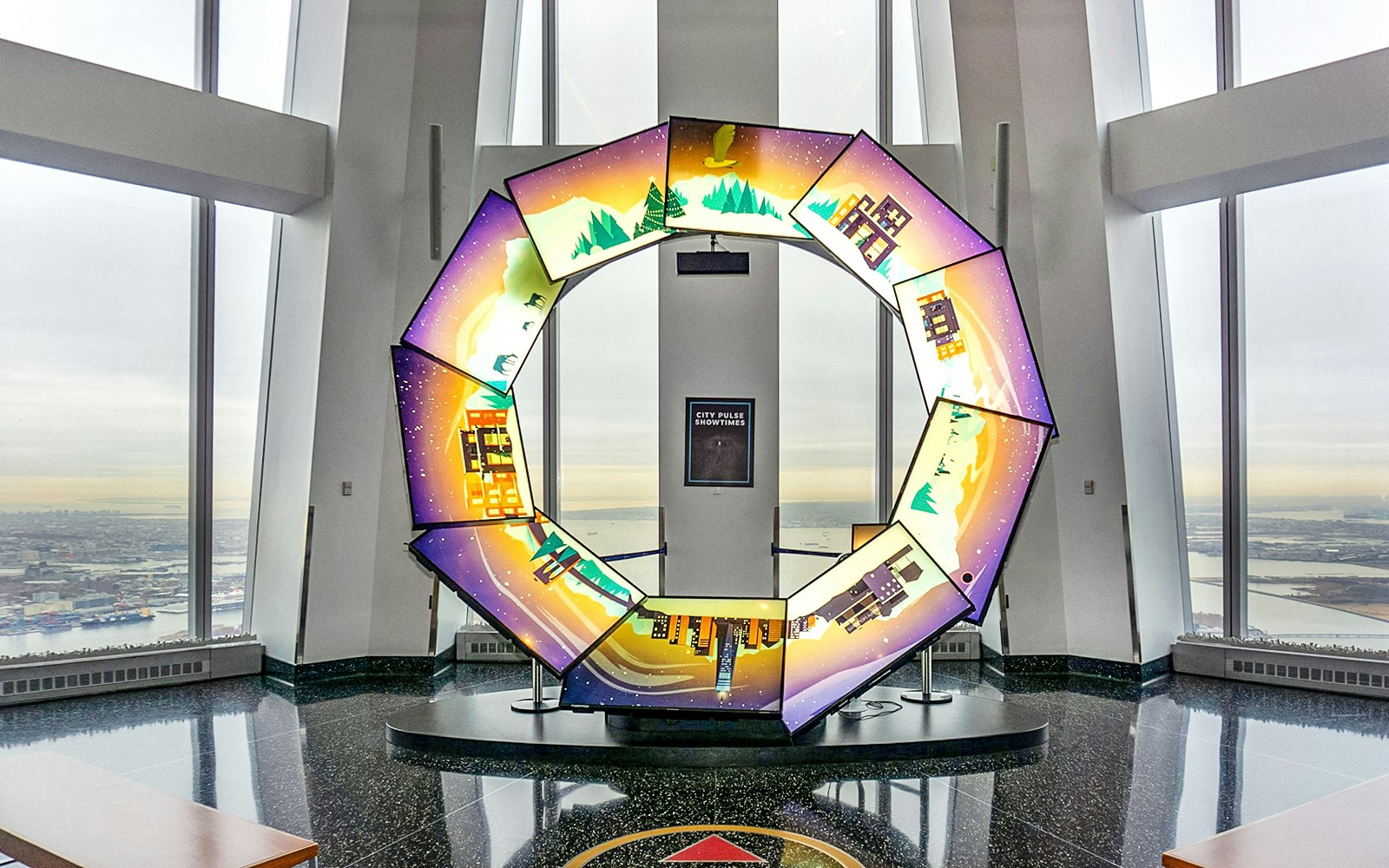 Interactive display at One World Observatory with city and nature scenes.