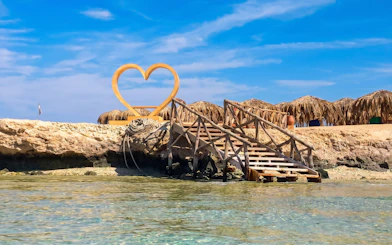 Wooden stairs leading to a heart-shaped sculpture on Orange Bay, Giftun Island, Hurghada.