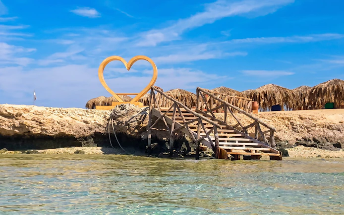 Wooden stairs leading to a heart-shaped sculpture on Orange Bay, Giftun Island, Hurghada.