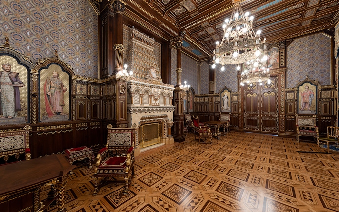 St Stephen's Hall interior with ornate woodwork, chandeliers, and historical murals.