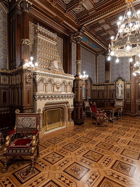 St Stephen's Hall interior with ornate woodwork, chandeliers, and historical murals.