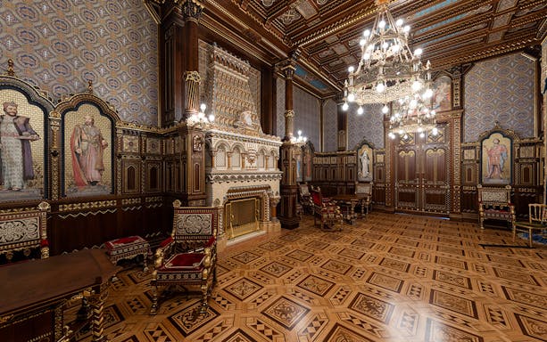 St Stephen's Hall interior with ornate woodwork, chandeliers, and historical murals.