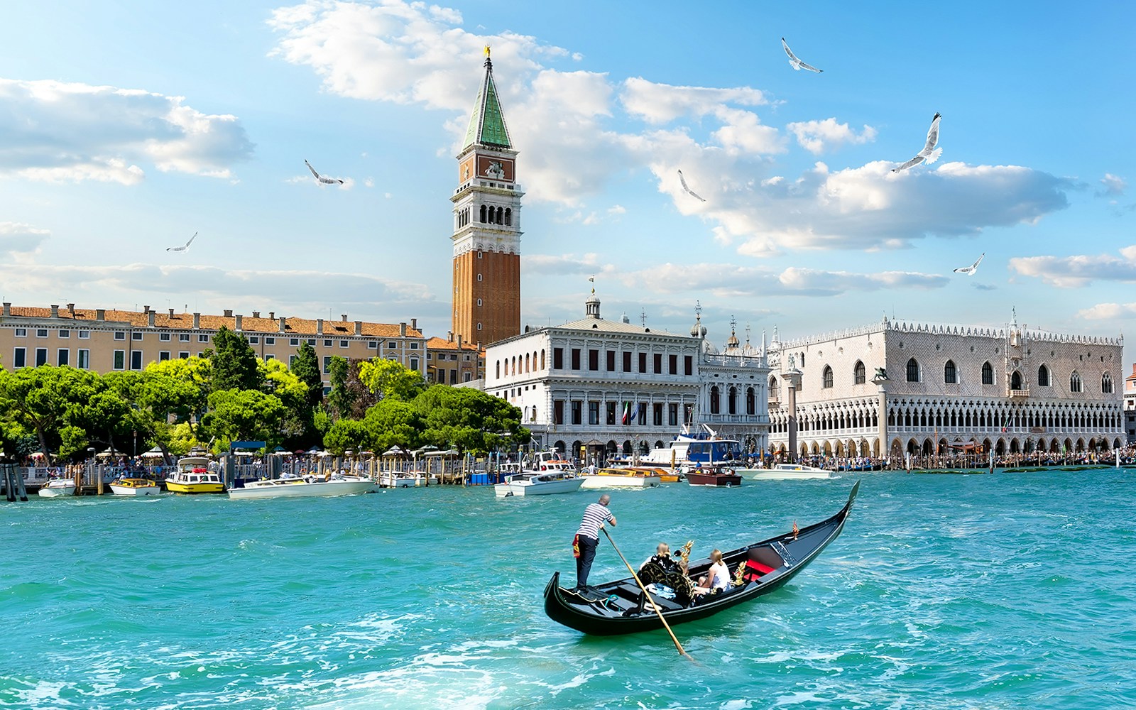 Gondola on Grand Canal with view of Doge's Palace and Bell Tower, Venice.