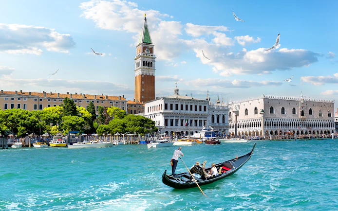 Gondola on Grand Canal with view of Doge's Palace and Bell Tower, Venice.