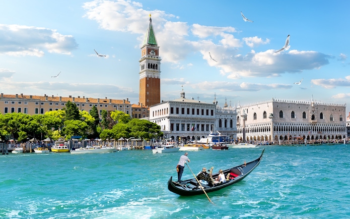 Gondola on Grand Canal with view of Doge's Palace and Bell Tower, Venice.