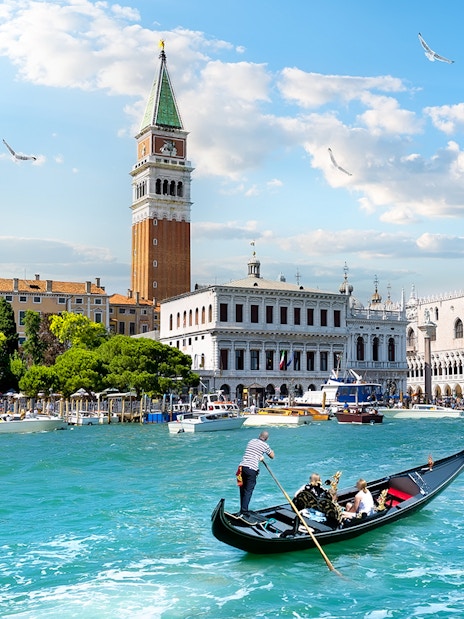 Gondola on Grand Canal with view of Doge's Palace and Bell Tower, Venice.