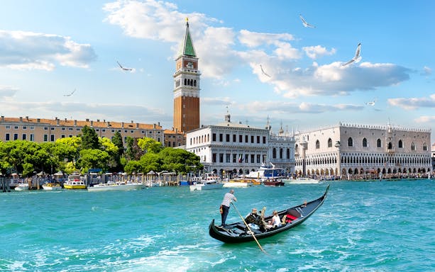 Gondola on Grand Canal with view of Doge's Palace and Bell Tower, Venice.