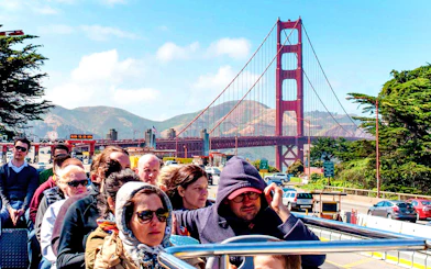 Tourists on open-top bus near Golden Gate Bridge, San Francisco.