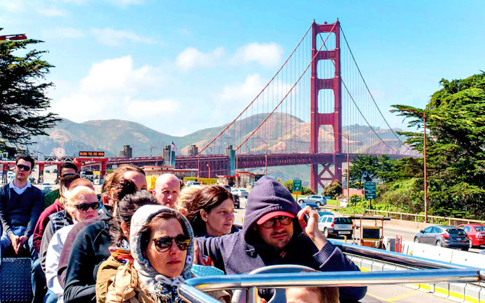 Tourists on open-top bus near Golden Gate Bridge, San Francisco.