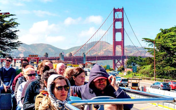 Tourists on open-top bus near Golden Gate Bridge, San Francisco.