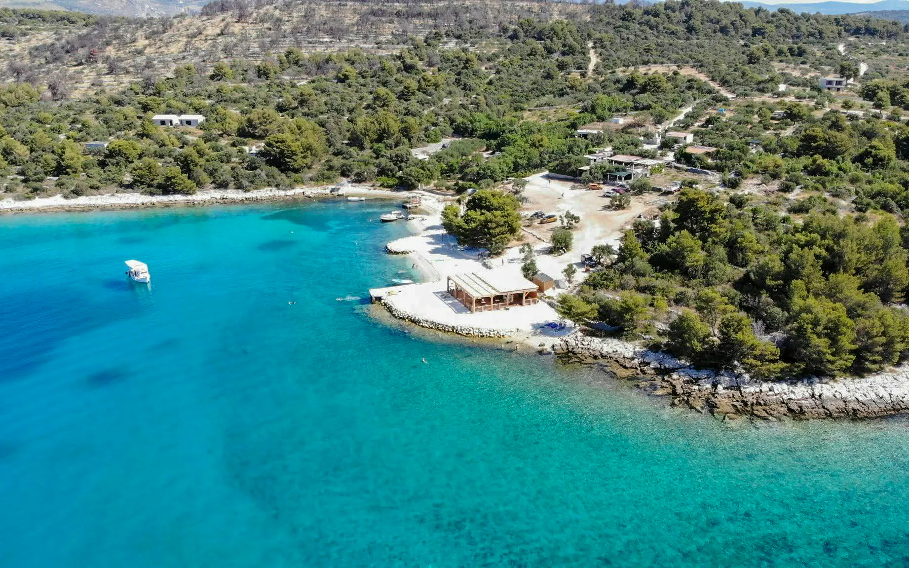 Aerial view of Blue Lagoon's turquoise waters and Maslinica's coastline, Trogir boat tour.