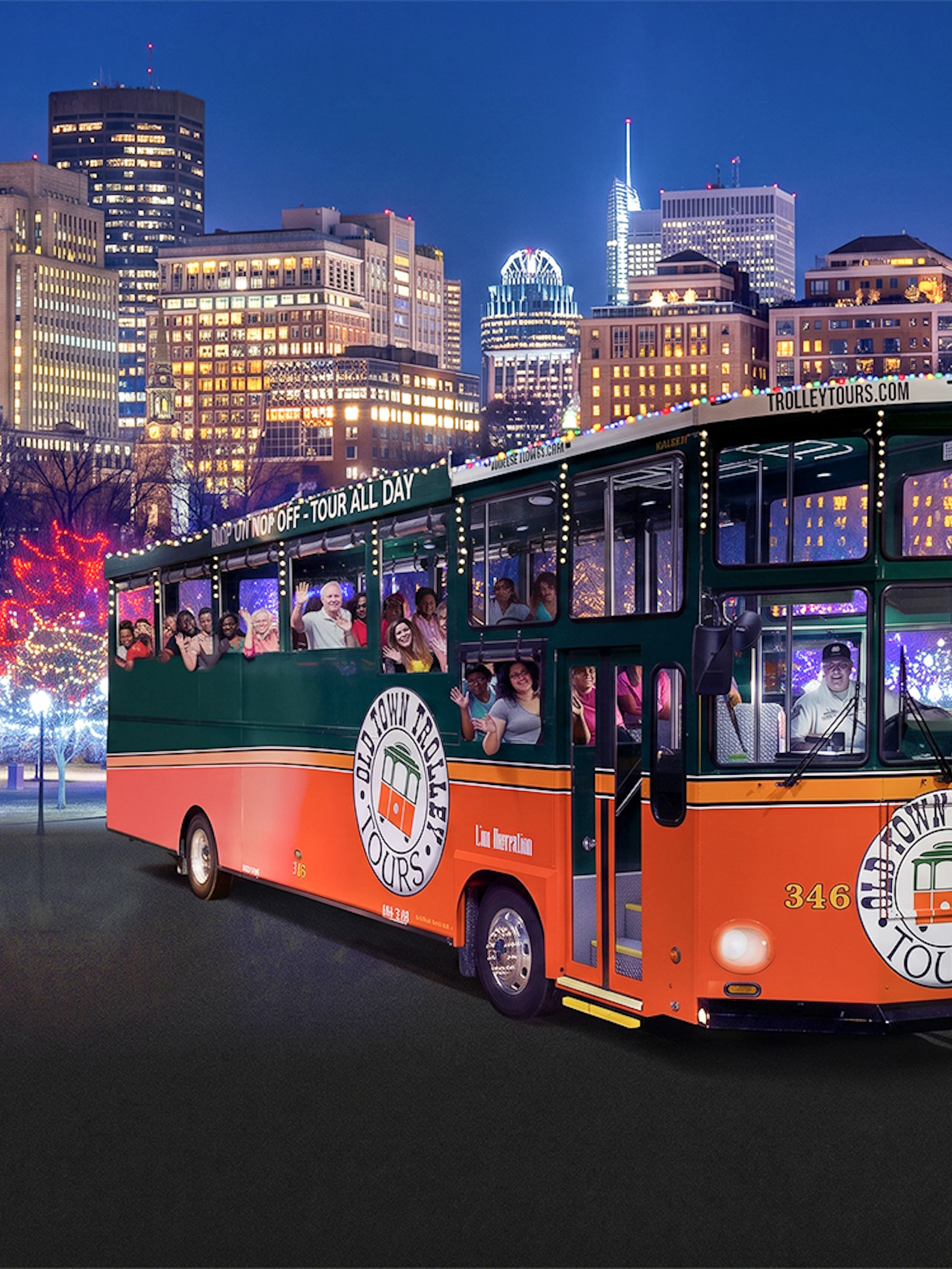 Trolley tour in Boston with festive lights and a large Christmas tree.