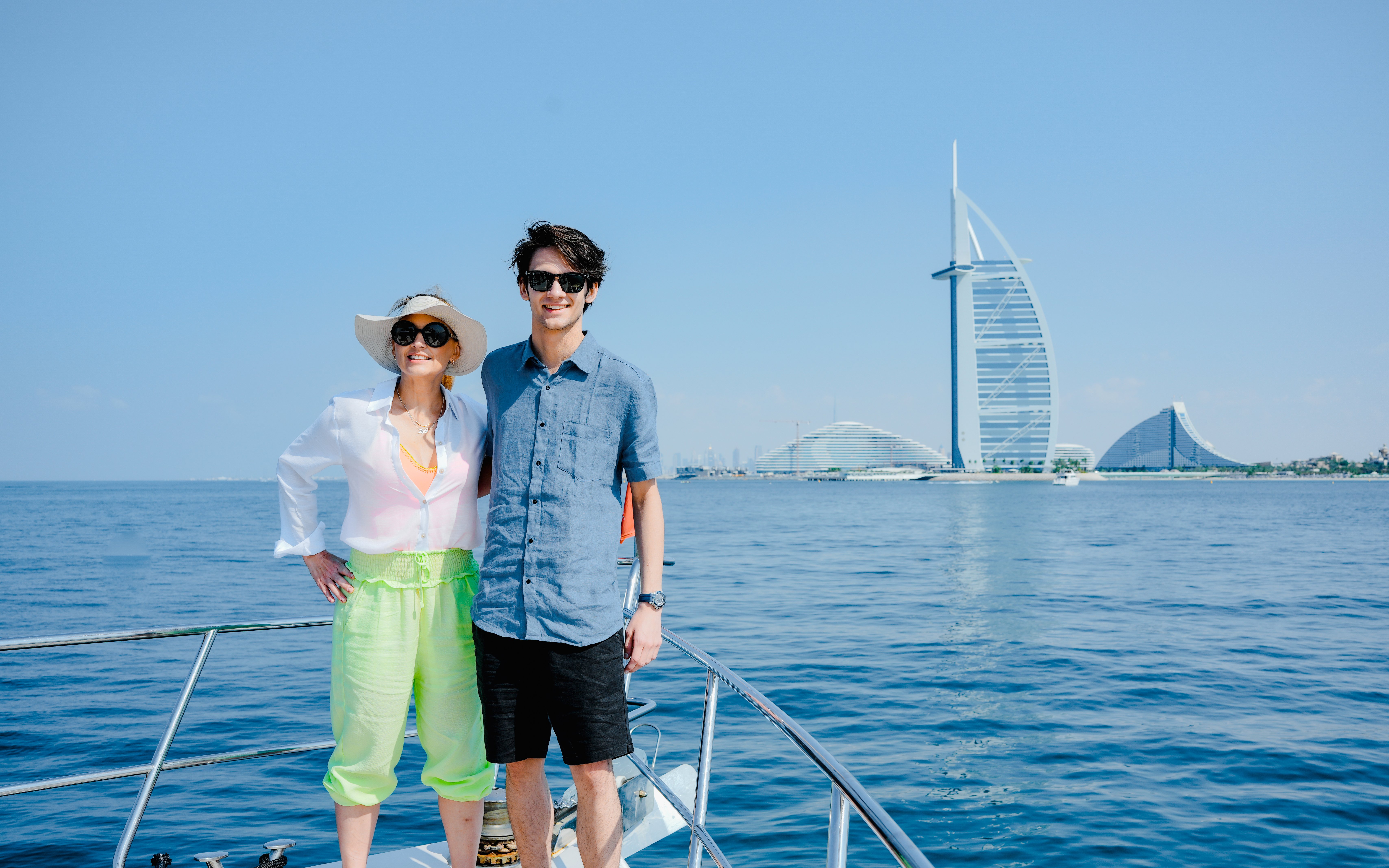 Couple on yacht with Burj Al Arab in background, Dubai Harbour Luxury Yacht Tour.