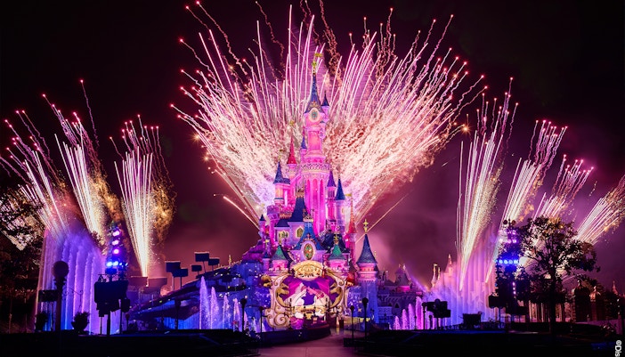 Fireworks display over Sleeping Beauty Castle during Disneyland Paris light show.