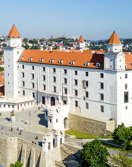 Bratislava Castle with red rooftops and towers, overlooking the cityscape in Slovakia.
