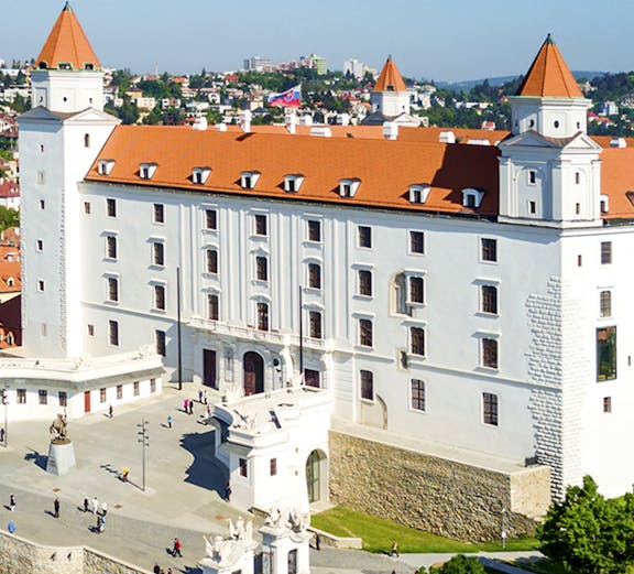 Bratislava Castle with red rooftops and towers, overlooking the cityscape in Slovakia.