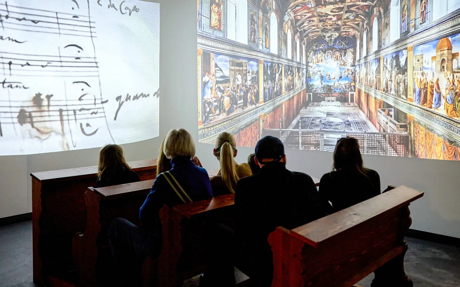 Guests viewing digital exhibits at Mozart Interactive Museum in Prague.
