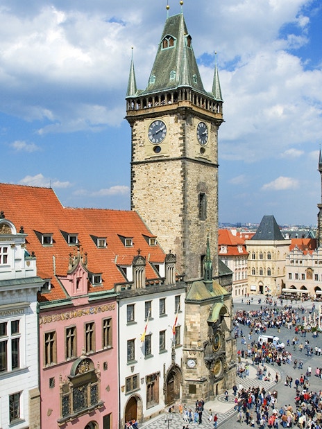 Prague Astronomical Tower overlooking a crowded square on a weekend.