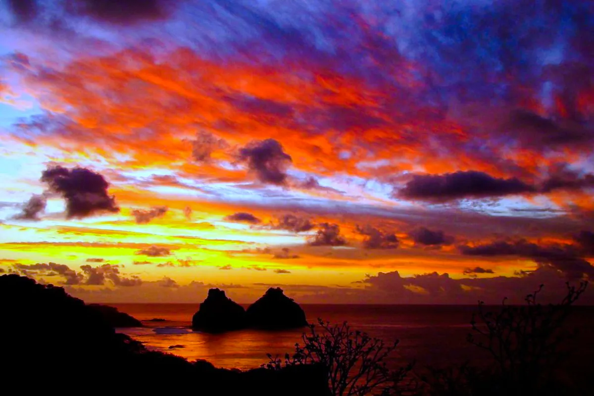 Sunset view over Dois Irmãos rocks at Sancho Beach, Fernando de Noronha, Brazil.