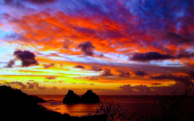 Sunset view over Dois Irmãos rocks at Sancho Beach, Fernando de Noronha, Brazil.