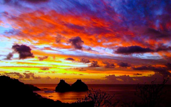 Sunset view over Dois Irmãos rocks at Sancho Beach, Fernando de Noronha, Brazil.