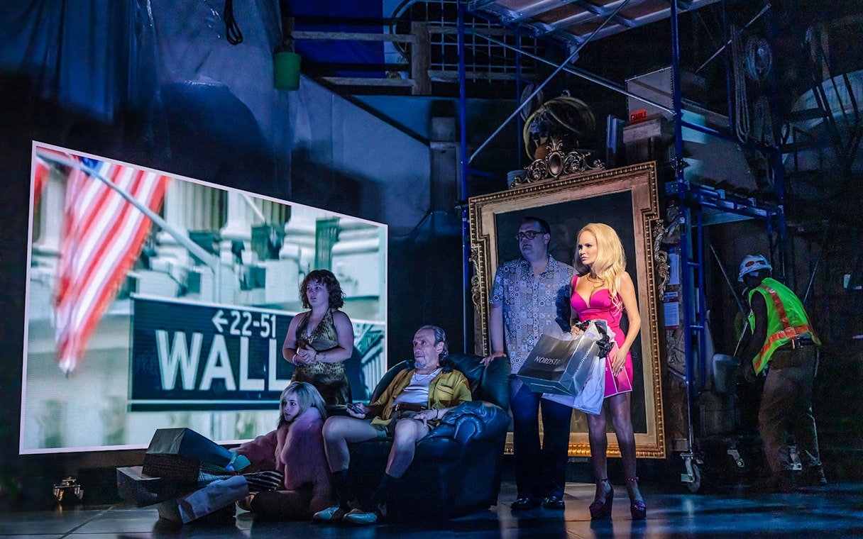 Group of people on stage with Wall Street sign and American flag in background, related to The Queen of Versailles.
