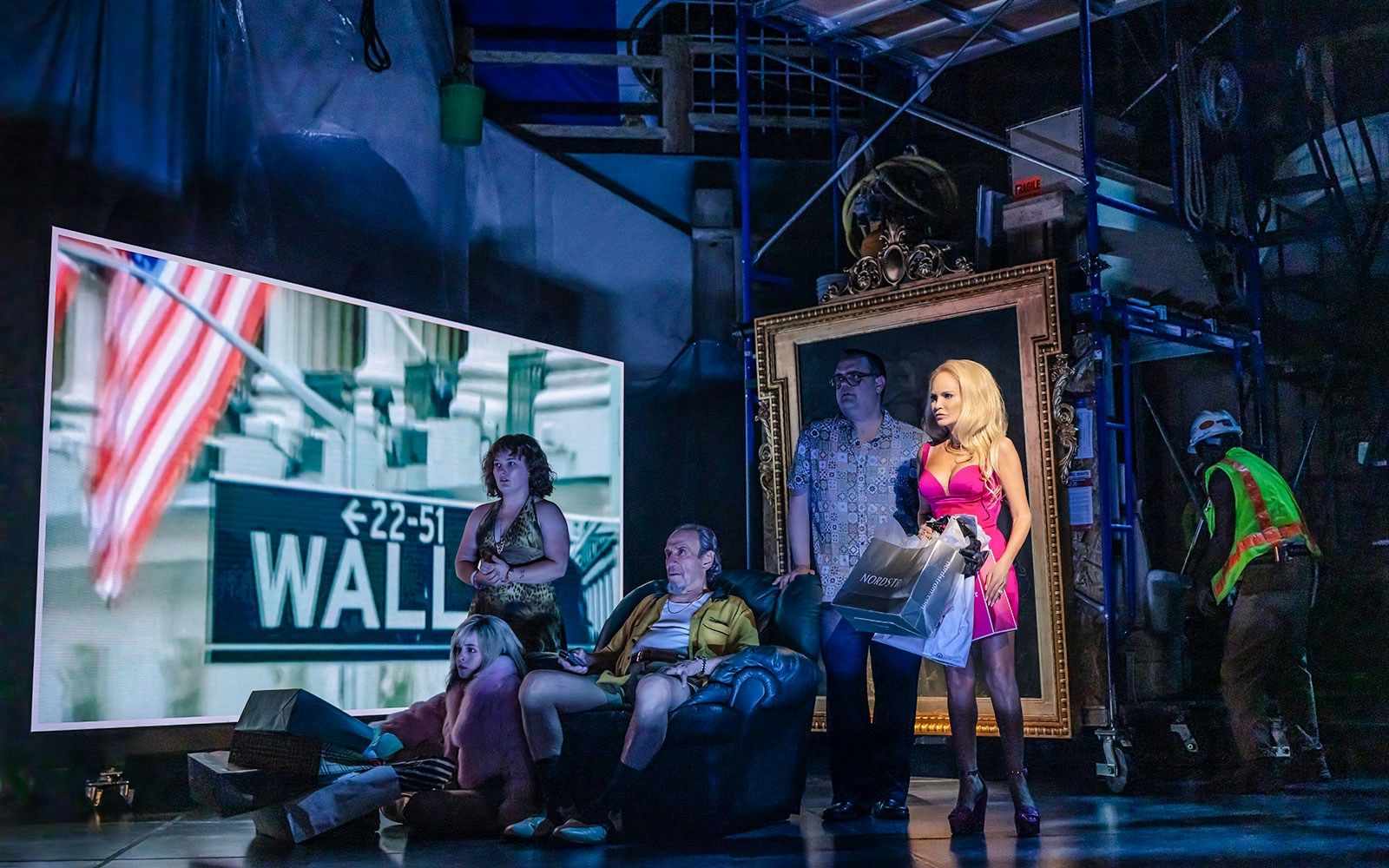 Group of people on stage with Wall Street sign and American flag in background, related to The Queen of Versailles.