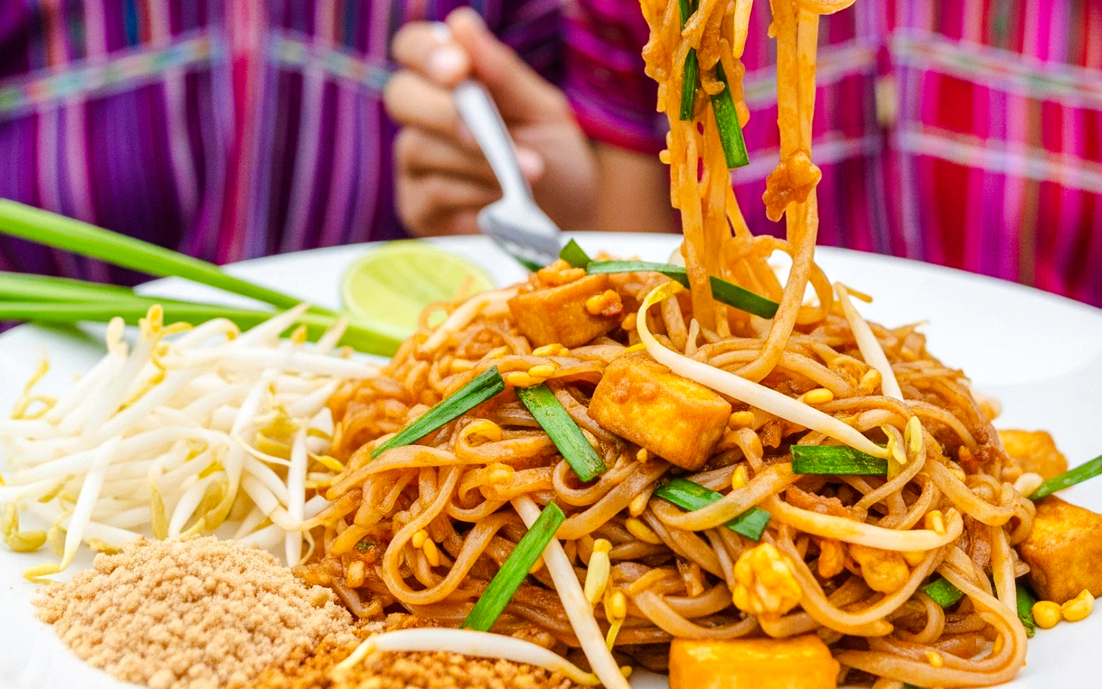 Traditional Thai pad thai with tofu and bean sprouts on a plate.