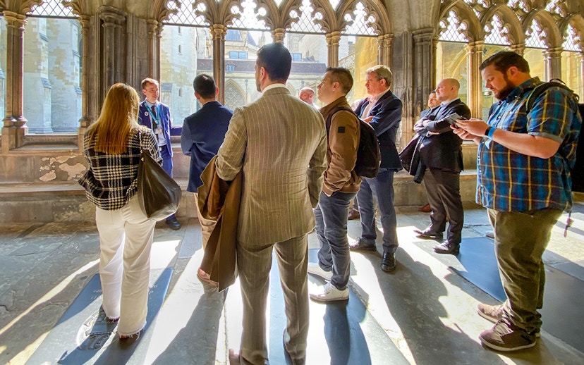 Tourists listening to a guide inside Westminster Abbey, London.