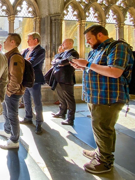 Tourists listening to a guide inside Westminster Abbey, London.