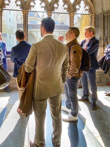 Tourists listening to a guide inside Westminster Abbey, London.
