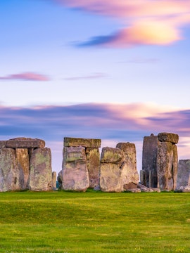 Stonehenge at sunset with vibrant sky in England.