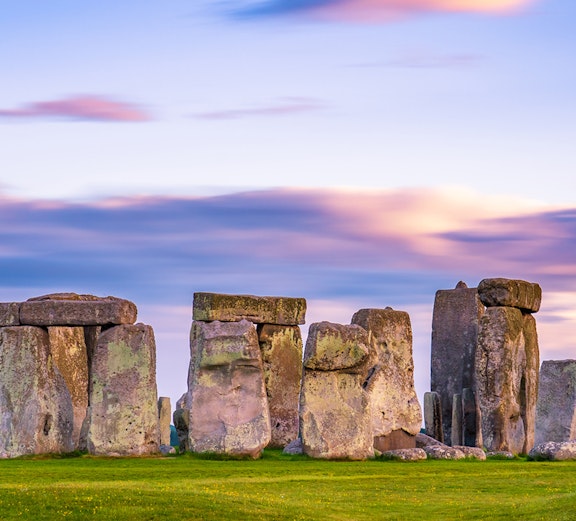 Stonehenge at sunset with vibrant sky in England.