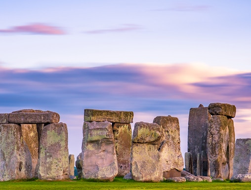Stonehenge at sunset with vibrant sky in England.