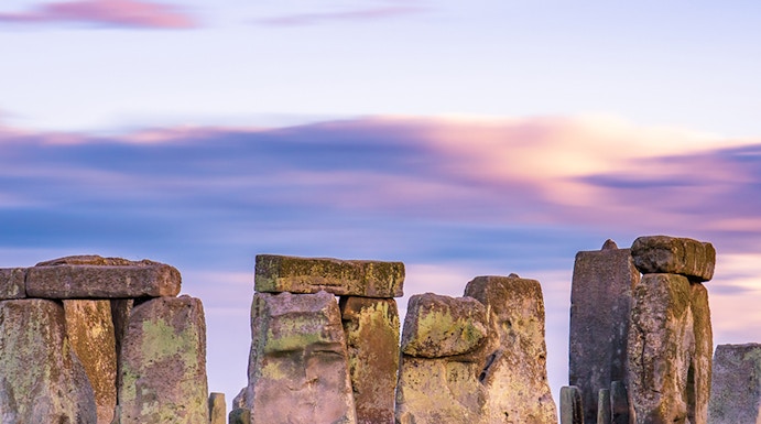 Stonehenge at sunset with vibrant sky in England.