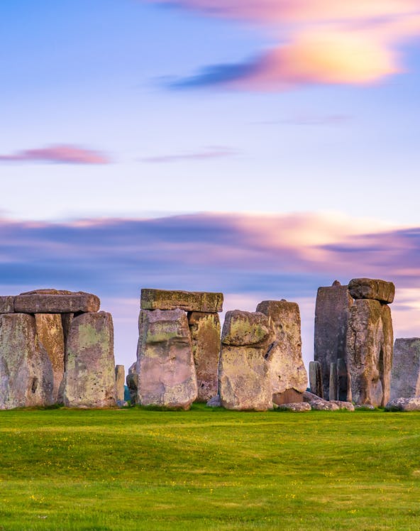 Stonehenge at sunset with vibrant sky in England.