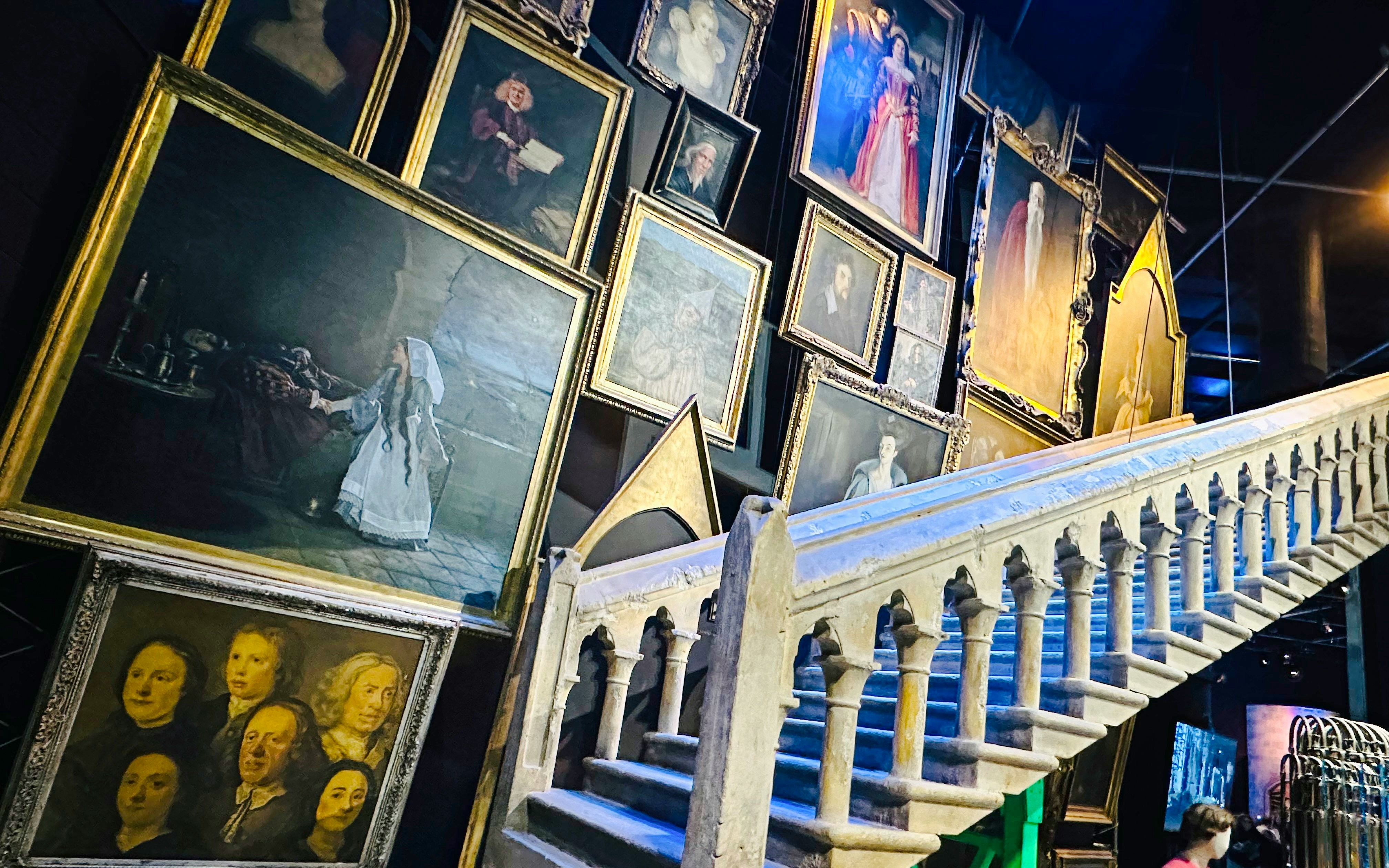 Portraits and staircase in Professor Dumbledore’s Office, showcasing magical ambiance.
