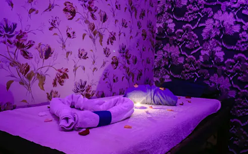 Traditional hammam massage room with towels and petals, Agadir.