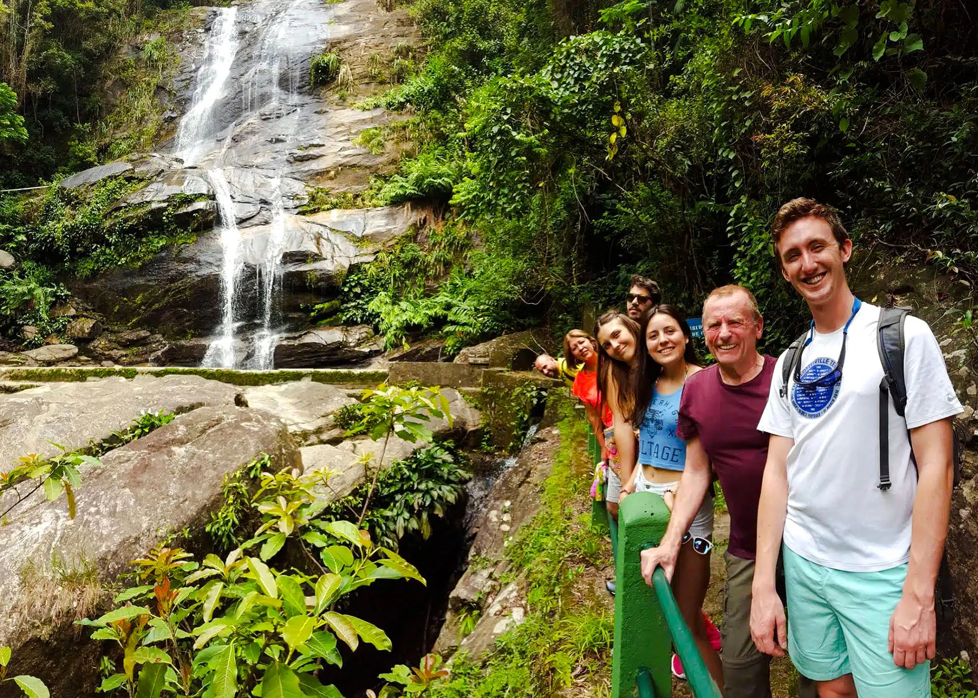 Group of tourists at a waterfall in Tijuca Forest, Rio de Janeiro.