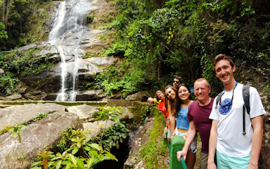 Group of tourists at a waterfall in Tijuca Forest, Rio de Janeiro.