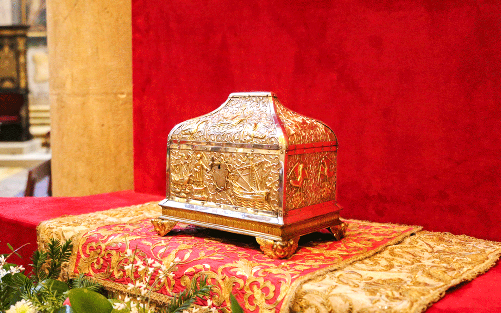 Gold ornate box on display in a treasury collection.