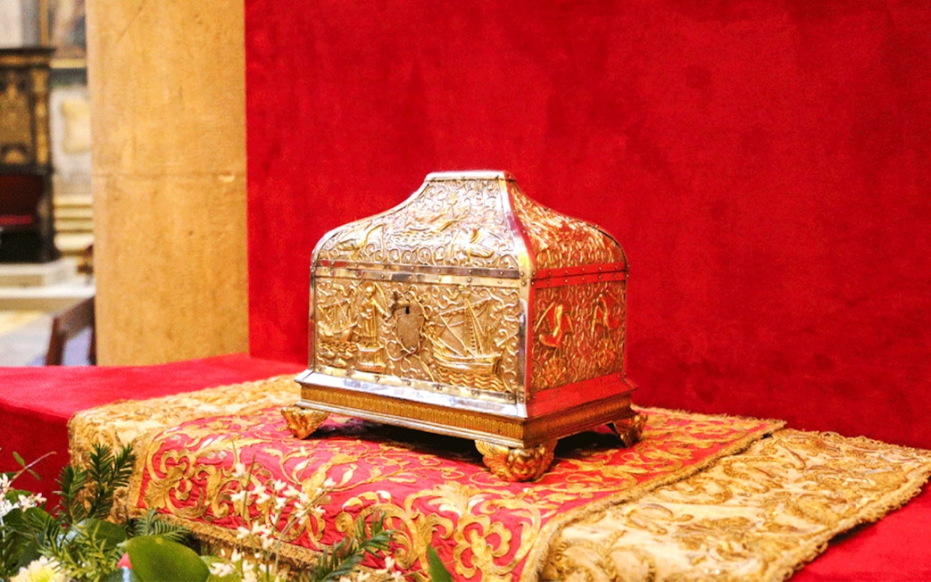 Gold ornate box on display in a treasury collection.
