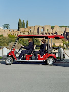 Golf cart tour near ancient ruins in Rome, Italy.