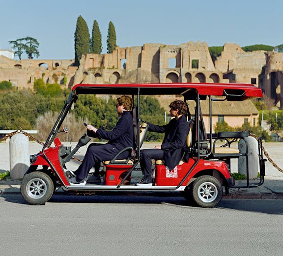 Golf cart tour near ancient ruins in Rome, Italy.
