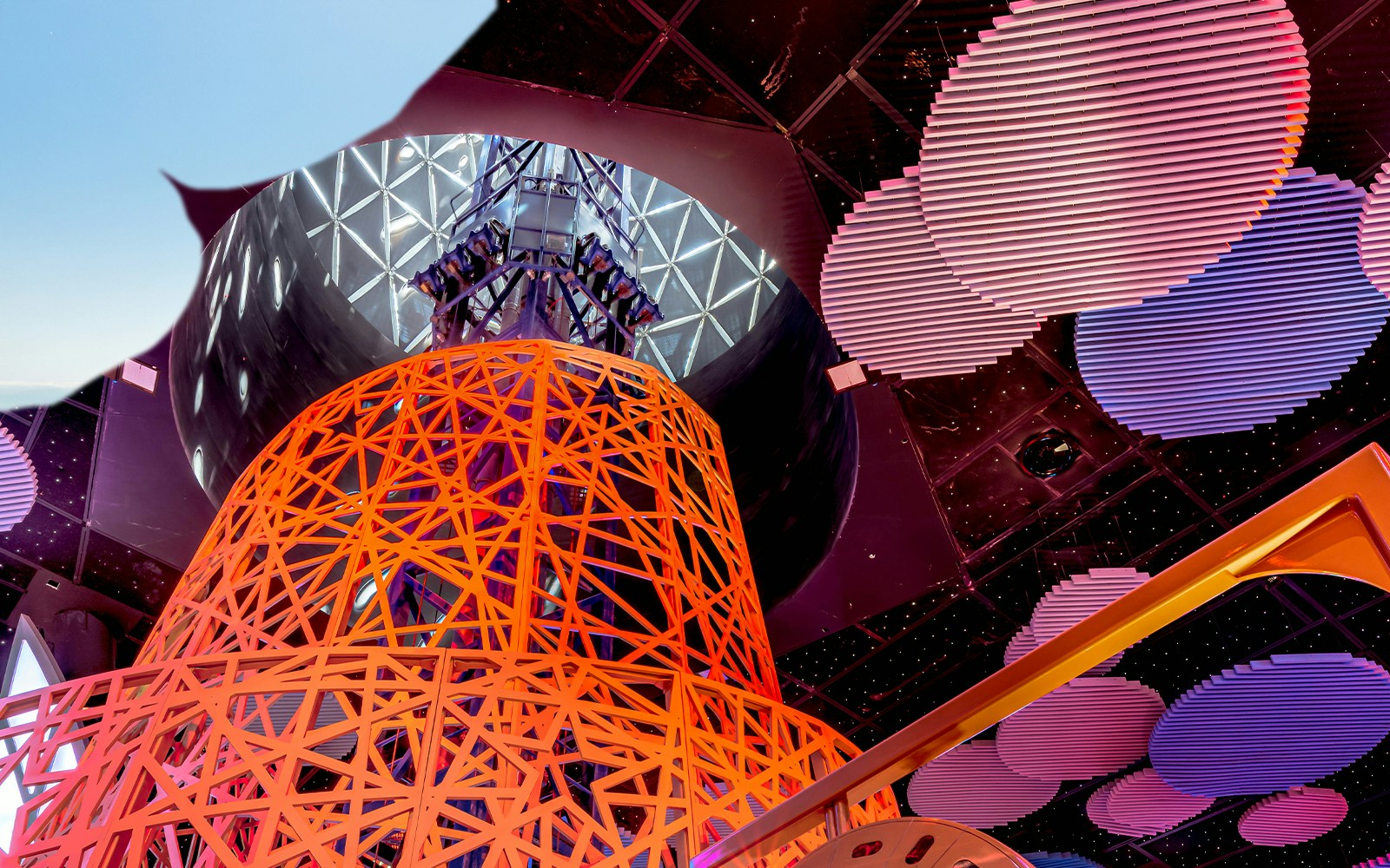 Doha Quest Magma Blast ride with vibrant geometric structure and ceiling lights.