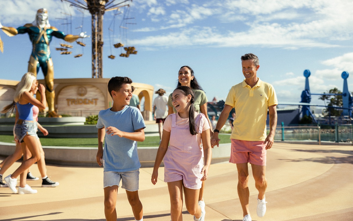 Tourists walking past Leviathan statue at Sea World.