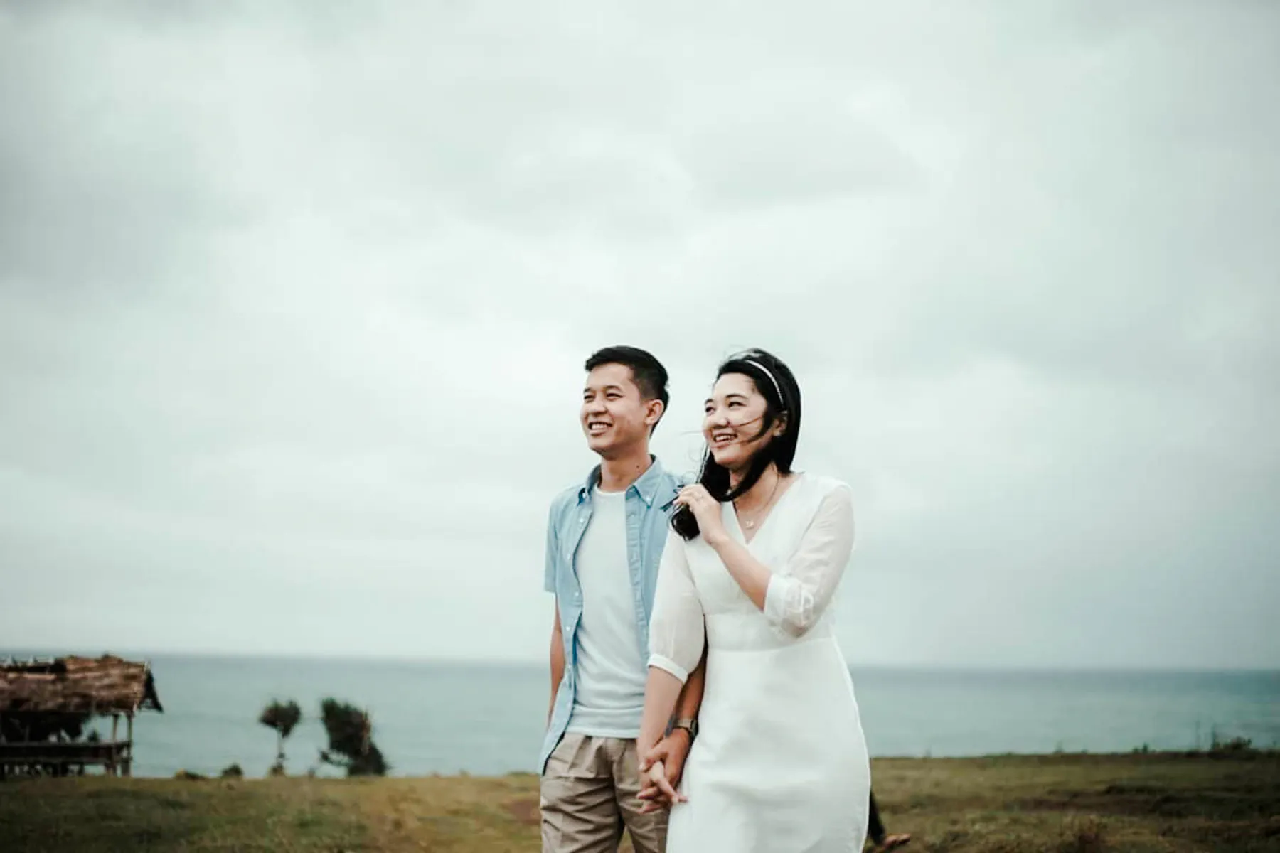Couple enjoying a professional photoshoot by the sea in Lombok.