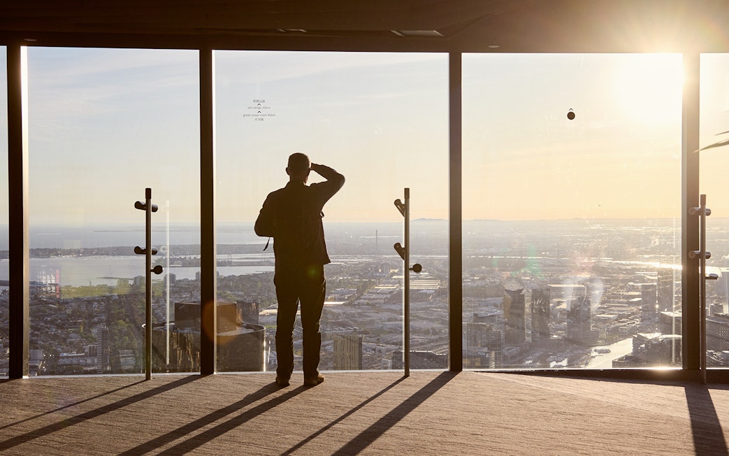 Person enjoying city view from Melbourne Skydeck at sunset, part of Max VR Experience.